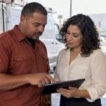 Plumbing owner reviewing website scope with designer