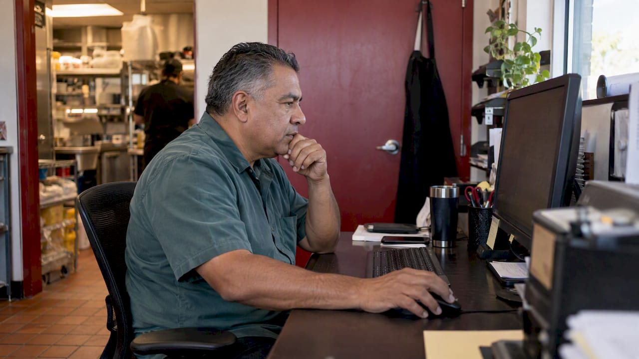 Restaurant owner reviewing an advertising budget